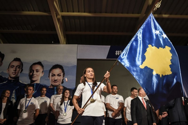 kosovar judoka majlinda kelmendi c waves kosovo 039 s national flag during the flag handover ceremony in pristina on july 29 2016 photo afp kosovar judoka majlinda kelmendi c waves kosovo 039 s national flag during the flag handover ceremony in pristina on july 29 2016 photo afp