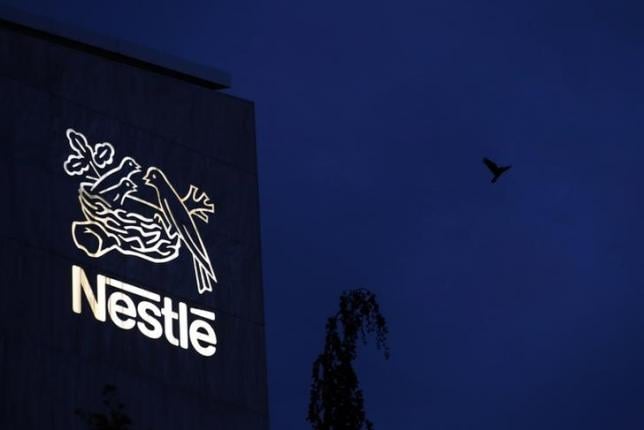 a bird flies past the logo at the headquarters of world food giant nestle in vevey october 16 2014 photo reuters