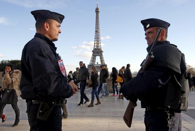 french police officers stand guard by the eiffel tower a week after a series of deadly attacks in the french capital paris photo reuters