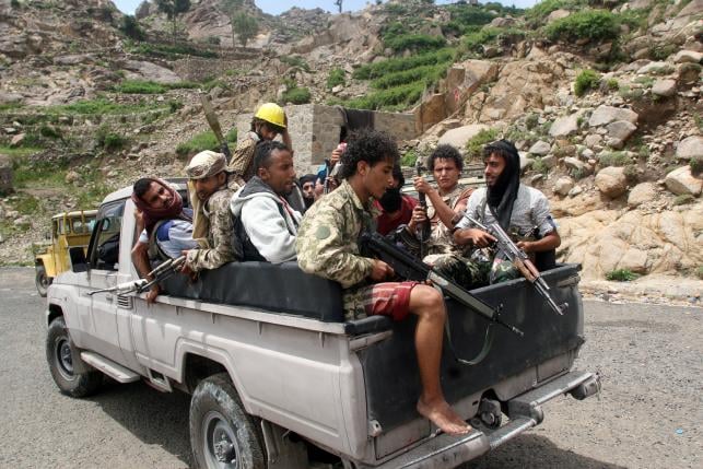 pro government fighters ride on the back of a patrol truck in a village taken by pro government forces from the iran allied houthi militia photo reuters