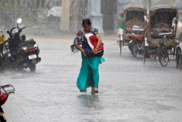 a woman walks during heavy rains in allahabad india july 29 2016 photo reuters a woman walks during heavy rains in allahabad india july 29 2016 photo reuters