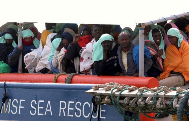 migrants wait to disembark from the medecins sans frontieres msf vessel at pozzallo 039 s harbour in sicily italy photo reuters