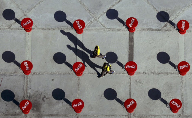 volunteers walk between coca cola branded tables near the main press centre and broadcast centre rio de janeiro brazil photo reuters volunteers walk between coca cola branded tables near the main press centre and broadcast centre rio de janeiro brazil photo reuters