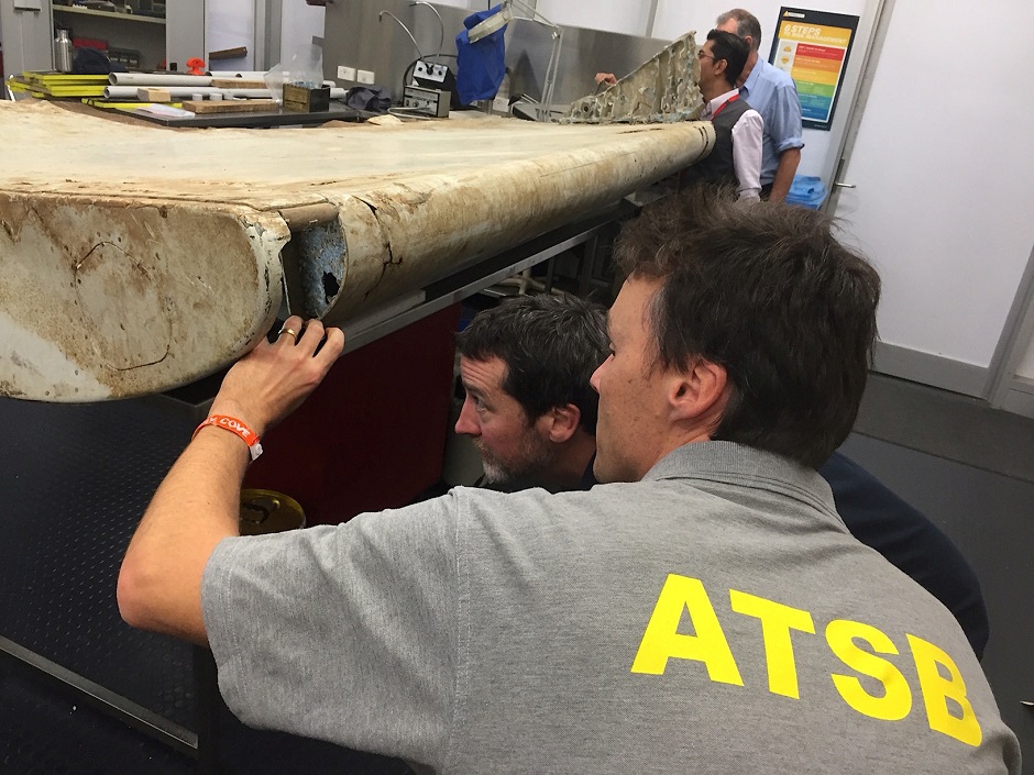 australian and malaysian officials examine aircraft debris at the australian transport safety bureau headquarters in canberra australia photo reuters