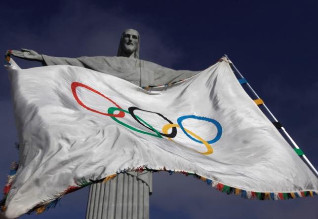 the olympic flag flies in front of quot christ the redeemer quot statue photo reuters