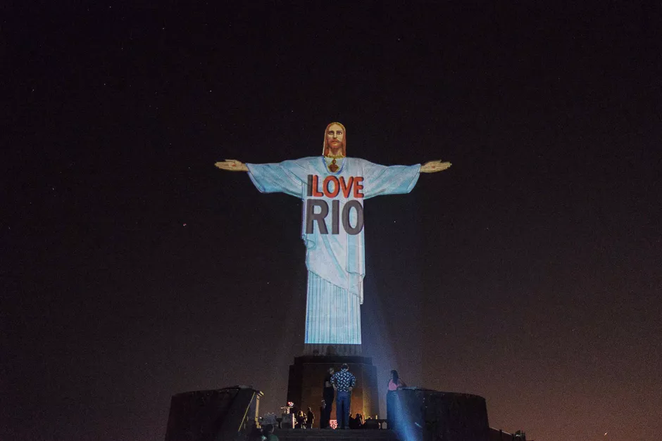 a projection is made over the statue of christ the redeemer as part of the launching of the new informative website quot iloverio com quot that tells about rio de janeiro 039 s various attractions in english ahead of the rio 2016 olympic games in rio de janeiro brazil photo afp a projection is made over the statue of christ the redeemer as part of the launching of the new informative website quot iloverio com quot that tells about rio de janeiro 039 s various attractions in english ahead of the rio 2016 olympic games in rio de janeiro brazil photo afp
