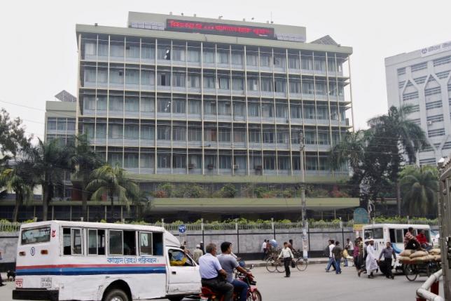 commuters pass by the front of the bangladesh central bank building in dhaka on march 8 2016 photo reuters