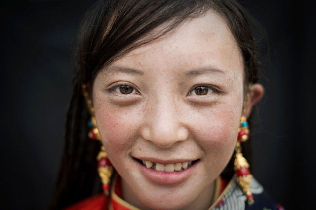 aan ethnic tibetan woman poses for a photo at a local government sponsored festival in yushu in the northwestern chinese province of qinghai photo afp aan ethnic tibetan woman poses for a photo at a local government sponsored festival in yushu in the northwestern chinese province of qinghai photo afp