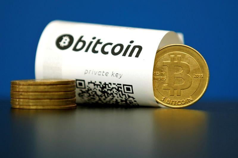 a bitcoin virtual currency paper wallet with qr codes and a coin are seen in an illustration picture taken at la maison du bitcoin in paris france may 27 2015 photo reuters