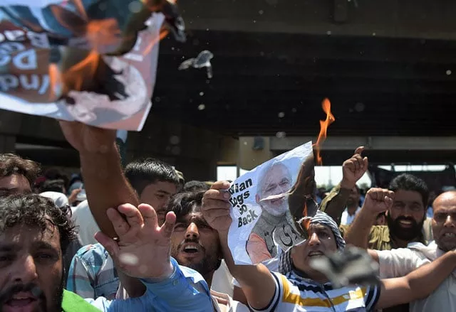 kashmiri protesters hold burning posters bearing the images of indian prime minister narendra modi and indian home minister rajnath singh as they block a main highway ahead of the arrival of indian home minister rajnath singh in islamabad on august 3 2016 photo afp kashmiri protesters hold burning posters bearing the images of indian prime minister narendra modi and indian home minister rajnath singh as they block a main highway ahead of the arrival of indian home minister rajnath singh in islamabad on august 3 2016 photo afp