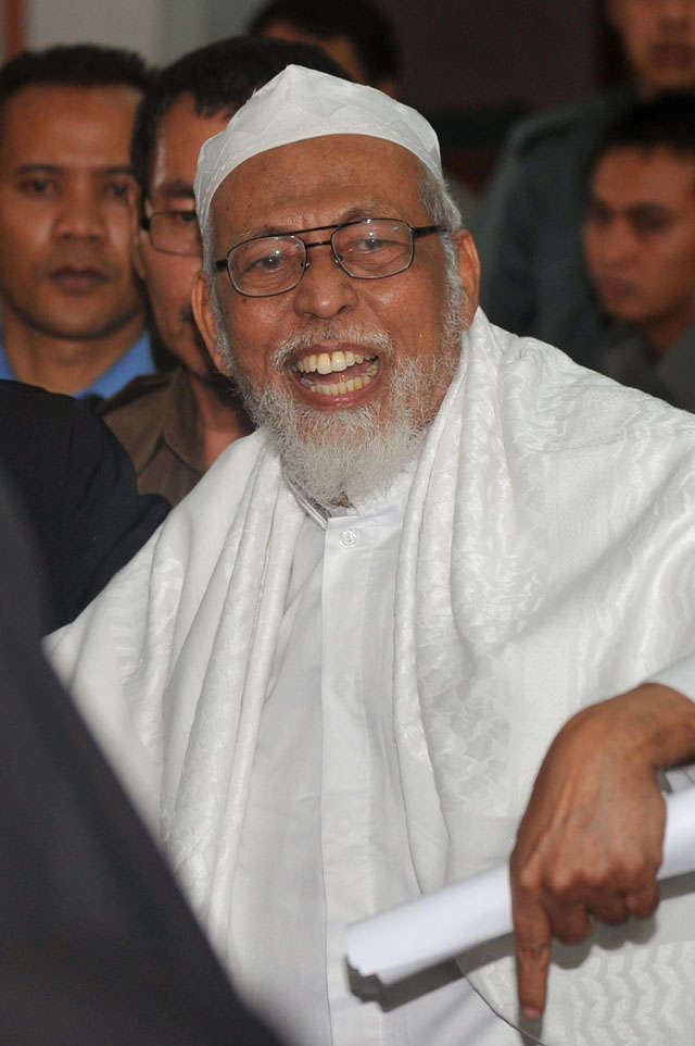 this file photo taken on june 16 2011 shows indonesian cleric abu bakar bashir gesturing to supporters in the gallery after he was convicted by the court in jakarta on terrorism charges photo afp