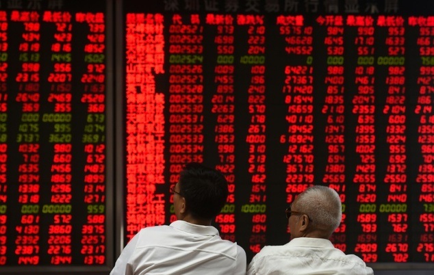investors monitor stock price movements at a securities company in beijing photo afp