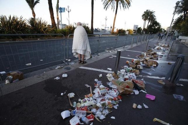 a man walks through debris scatterd on the street the day after the nice attack photo reuters