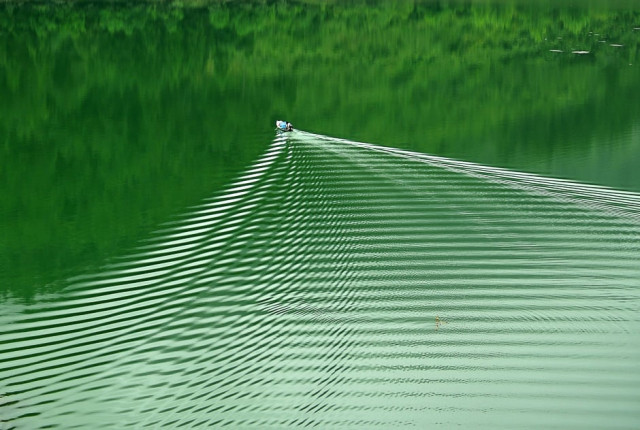 a man takes a fishing boat on a lake in shi 039 en hubei province china photo reuters