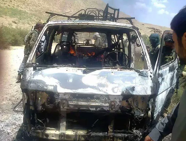 afghan security forces inspect a burnt out vehicle believed to have transported foreign tourists who came under attack from taliban militants in western herat province on august 5 2016 photo afp afghan security forces inspect a burnt out vehicle believed to have transported foreign tourists who came under attack from taliban militants in western herat province on august 5 2016 photo afp