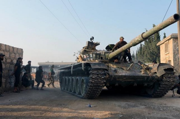 rebel fighters ride a tank in an artillery academy of aleppo syria photo reuters