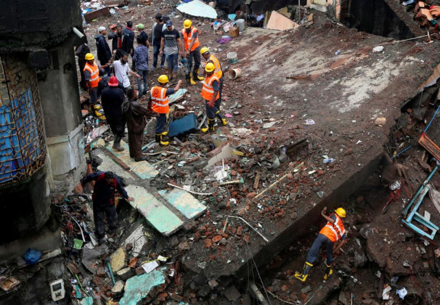 rescuers search for survivors at the site of a collapsed residential building on the outskirts of mumbai photo reuters rescuers search for survivors at the site of a collapsed residential building on the outskirts of mumbai photo reuters