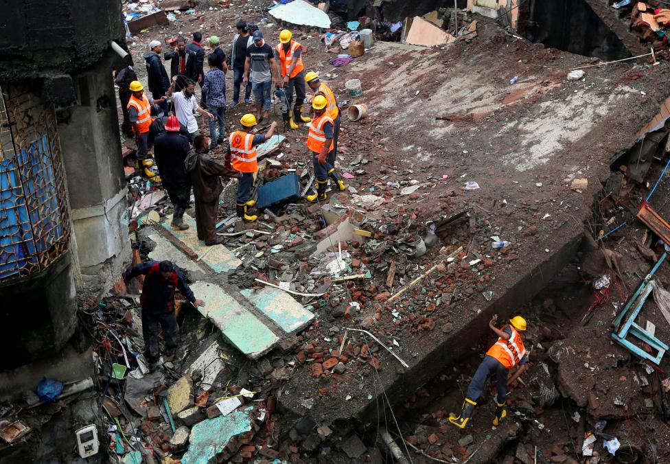 rescuers search for survivors at the site of a collapsed residential building on the outskirts of mumbai photo reuters