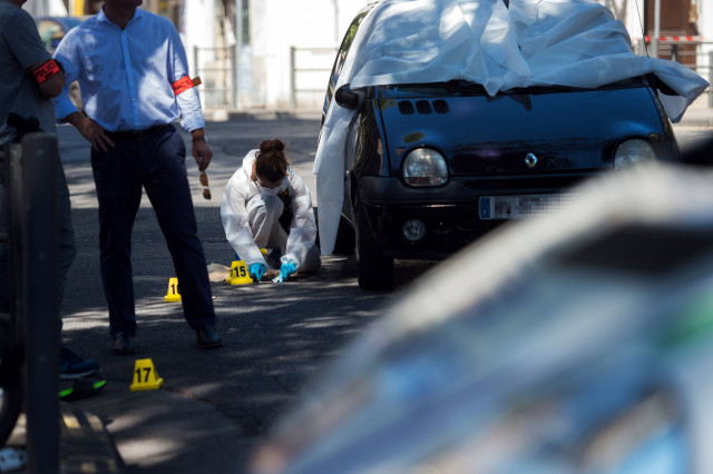 a forensic police officer investigates by the car where two men in their twenties were shot dead near the train station saint charles in marseille southern france on august 7 2016 photo afp a forensic police officer investigates by the car where two men in their twenties were shot dead near the train station saint charles in marseille southern france on august 7 2016 photo afp
