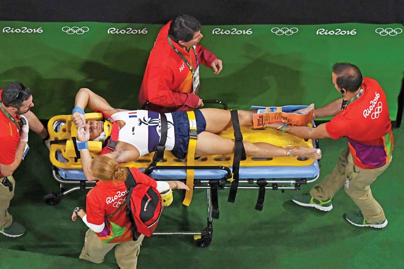 an overview shows france s samir ait said being stretchered off after being injured while competing in the qualifying round for the men s vault event of the artistic gymnastics at the olympic arena photo afp