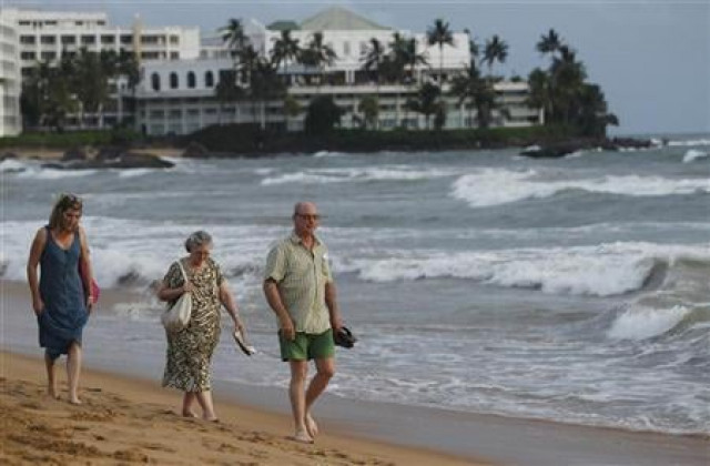 tourists walk along the mount lavinia beach in colombo june 13 2011 photo reuters tourists walk along the mount lavinia beach in colombo june 13 2011 photo reuters