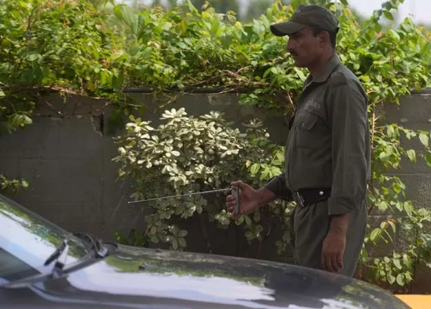 a pakistani private security guard uses an explosives detector to search a vehicle at a mall entrance in islamabad photo afp a pakistani private security guard uses an explosives detector to search a vehicle at a mall entrance in islamabad photo afp