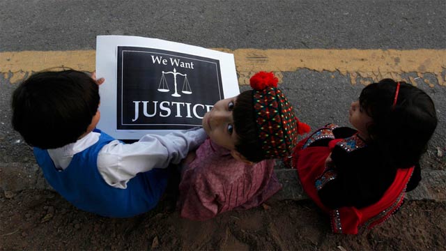 children sit with a placard on a roadside during a protest by members of a civil society against the rape of a five year old girl in lahore in islamabad photo reuters