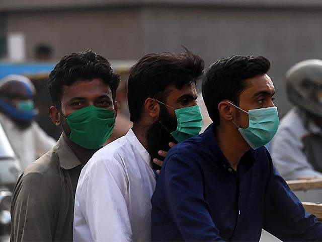 commuters wearing face masks ride on a bike photo afp
