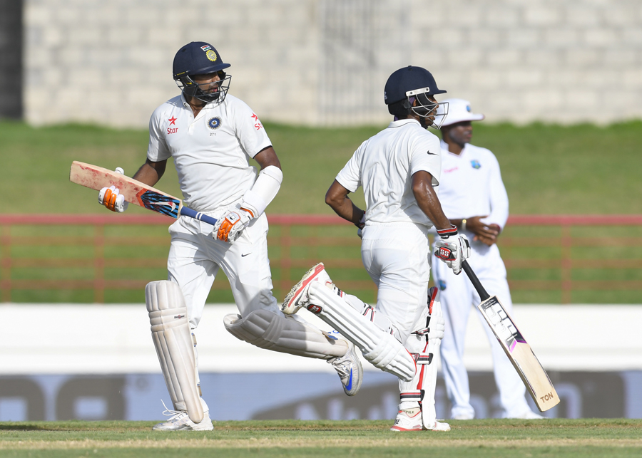 ravichandran ashwin l and wriddhiman saha r of india partnership during day 1 of the 3rd test between west indies and india august 9 2016 at darren sammy national cricket stadium gros islet st lucia photo afp