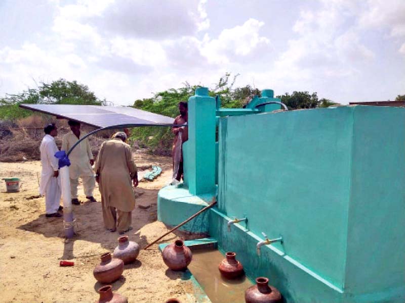 villagers draw water from a solar powered ro plant at a school set up by the foe access to clean water has boosted attend ance at schools photo courtesy friends of education foundation