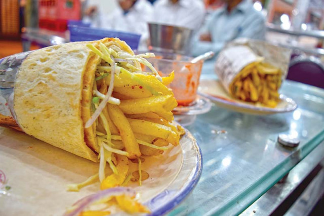 a kabuli burger ready to be served to a customer photo express a kabuli burger ready to be served to a customer photo express