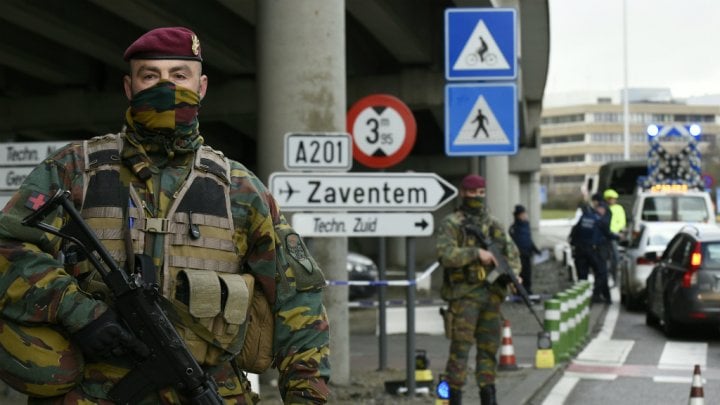 policemen and soldiers perform security checks at the brussels airport entrance on march 29 2016 photo afp