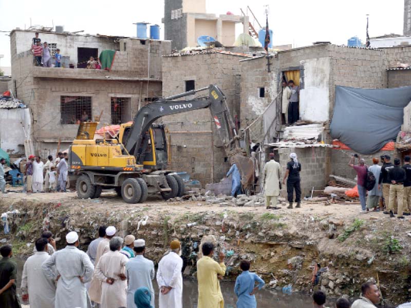 residents poured into the streets in fear and anticipation as kmc teams launched an anti encroachment operation in the sur roundings of gujjar nullah on wednesday photo online