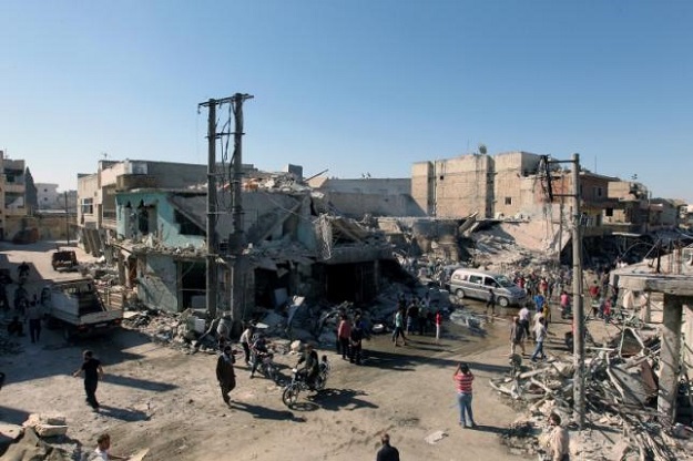 people inspect a site hit by airstrikes in the rebel held town of atareb in aleppo province syria photo reuters