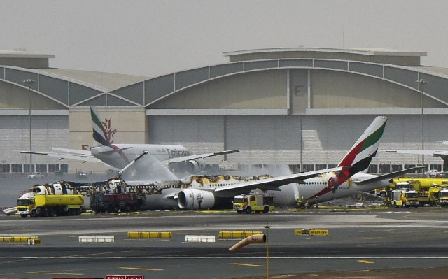 a picture shows a boeing 777 of the uae airliner emirates after it caught fire following a crash landing at dubai airport on august 3 2016 photo afp