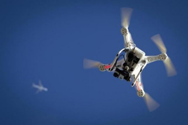 an airplane flies over a drone in the brooklyn borough of new york january 1 2015 photo reuters an airplane flies over a drone in the brooklyn borough of new york january 1 2015 photo reuters