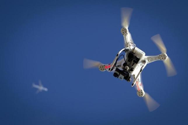 an airplane flies over a drone in the brooklyn borough of new york january 1 2015 photo reuters