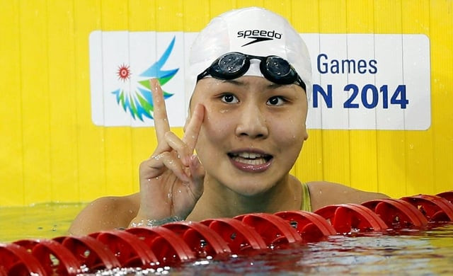 chen xinyi celebrates after winning the women 039 s 50m freestyle final swimming competition at the munhak park tae hwan aquatics center during the 17th asian games in incheon on september 26 2014 photo reuters