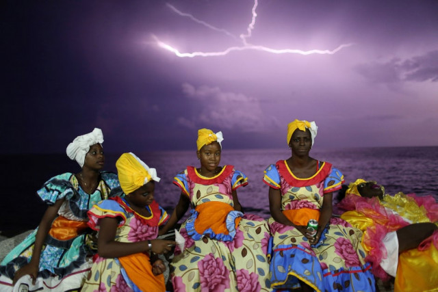 revellers chat on havana 039 s malecon seafront before performing at a carnival parade cuba august photo reuters