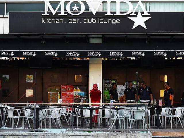 malaysian forensic experts inspect the site of grenade attack at a restaurrant in puchong district outside of kuala lumpur on june 28 2016 photo afp