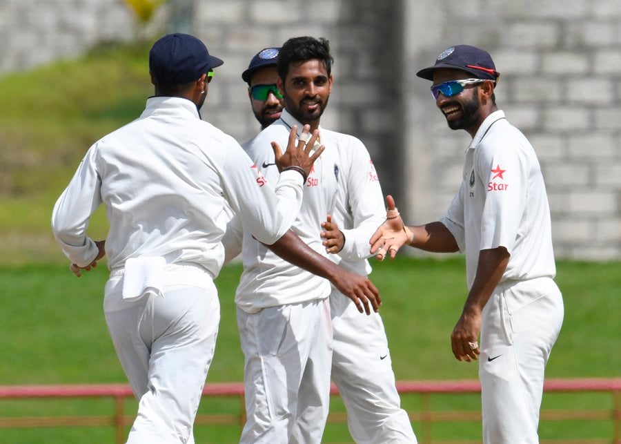 bhuvneshwar kumar c celebrates with ajinkya rahane r of india taking 5 west indies wickets for 33 runs during day 4 of the 3rd test between west indies and india on august 12 2016 at darren sammy national cricket stadium gros islet st lucia photo afp