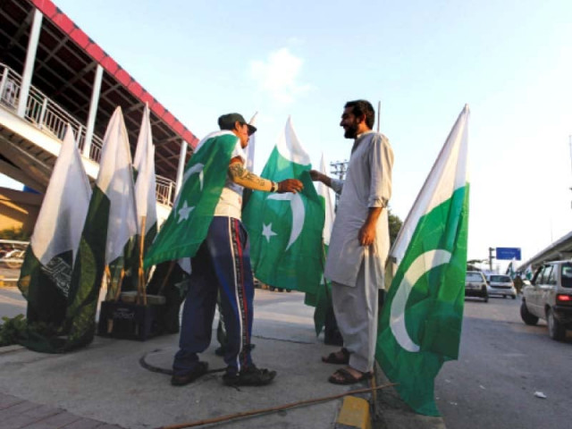 a man buys a flag along a roadside in rawalpindi photo reuters a man buys a flag along a roadside in rawalpindi photo reuters