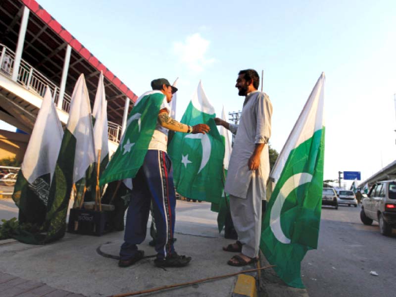 a man buys a flag along a roadside in rawalpindi photo reuters