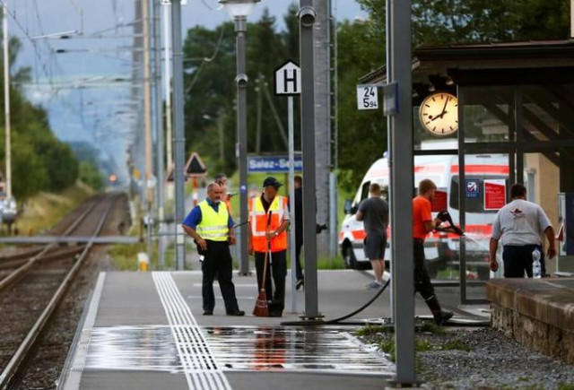 a swiss police officer stands near workers cleaning a platform after a 27 year old swiss man 039 s attack on a swiss train at the railway station in the town of salez switzerland august 13 2016 photo reuters a swiss police officer stands near workers cleaning a platform after a 27 year old swiss man 039 s attack on a swiss train at the railway station in the town of salez switzerland august 13 2016 photo reuters