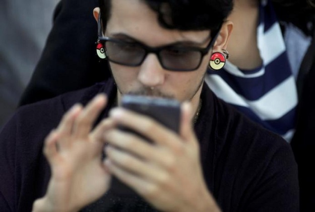 a boy plays pokemon go in an urban park in rio de janeiro photo reuters