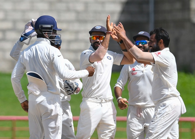 virat kohli c celebrates with teammates at darren sammy national cricket stadium on gros islet st lucia photo afp