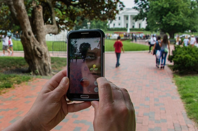 a woman playing pokemon go in front of the white house photo afp a woman playing pokemon go in front of the white house photo afp