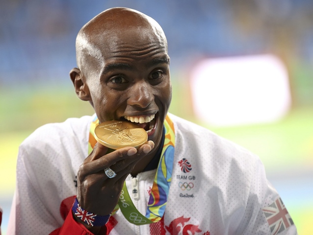 mo farah bites his gold medal photo reuters