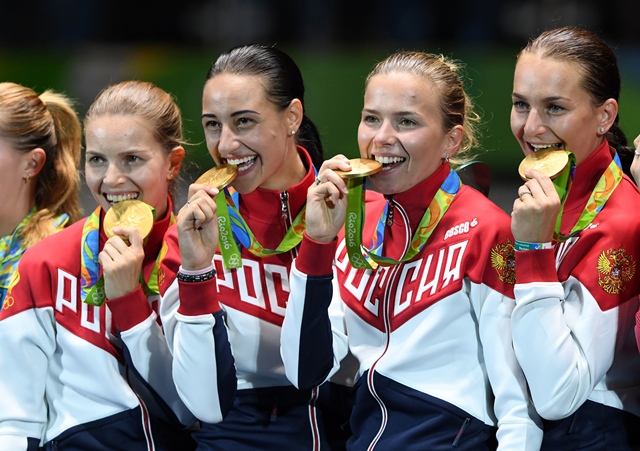 Ever Wonder Why Olympians Bite Their Medals