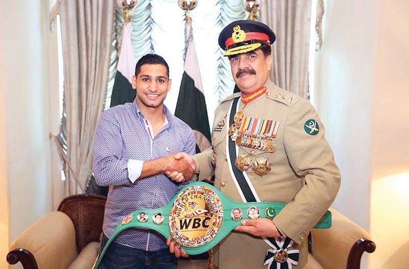 boxer amir khan presents a championship belt to army chief general raheel sharif at the ghq in rawalpindi photo app